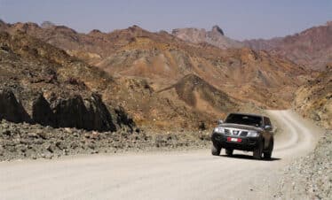 4x4 roulant sur une route au coeur d'un paysage de montagnes désertes